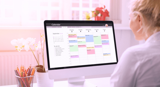 A professional setting where an individual is coordinating appointments and planning an event, with a calendar, notepad, and a laptop open, showcasing organization and attention to detail in event management.