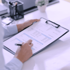 A skilled accountant reviewing financial documents and calculations, representing MHR Solutions' commitment to providing comprehensive accounting support for businesses to ensure accurate financial management and compliance.