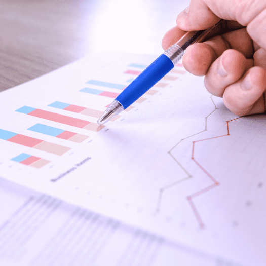 A business owner reviewing payroll reports with a look of relief and satisfaction, symbolizing the peace of mind provided by MHR Solutions’ payroll services, ensuring timely and accurate payments.