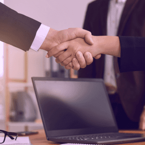 A handshake between a client and a consultant from MHR Solutions, symbolizing a successful partnership in payroll services and collaboration for business growth.